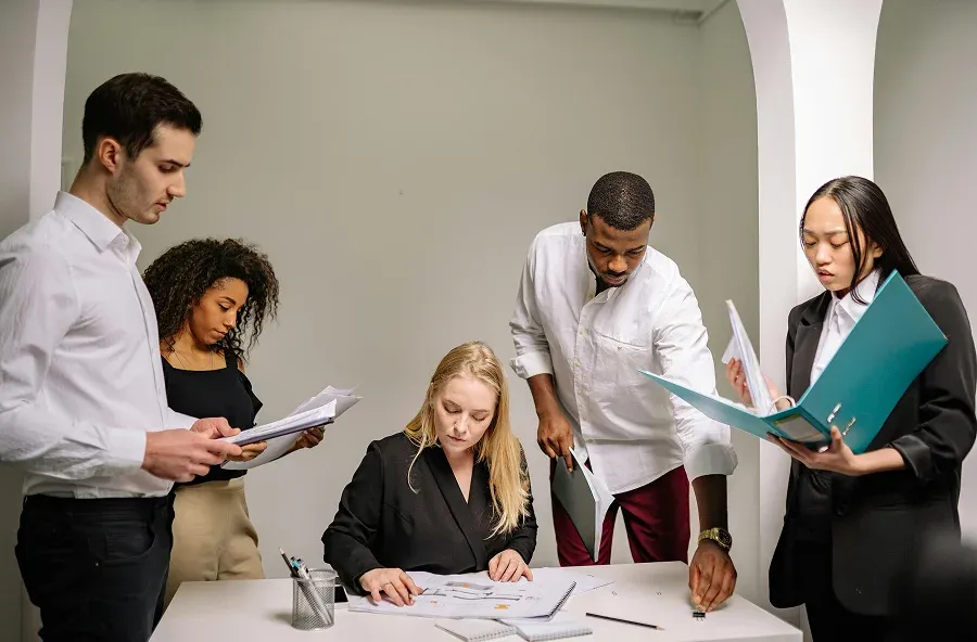 Consultants reviewing documents around a table