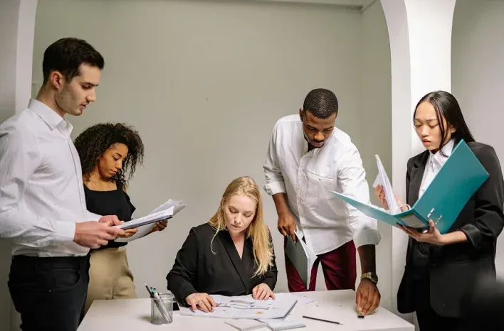Consultants reviewing documents around a table