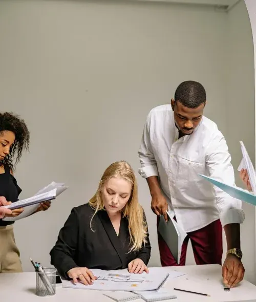 Consultants reviewing documents around a table